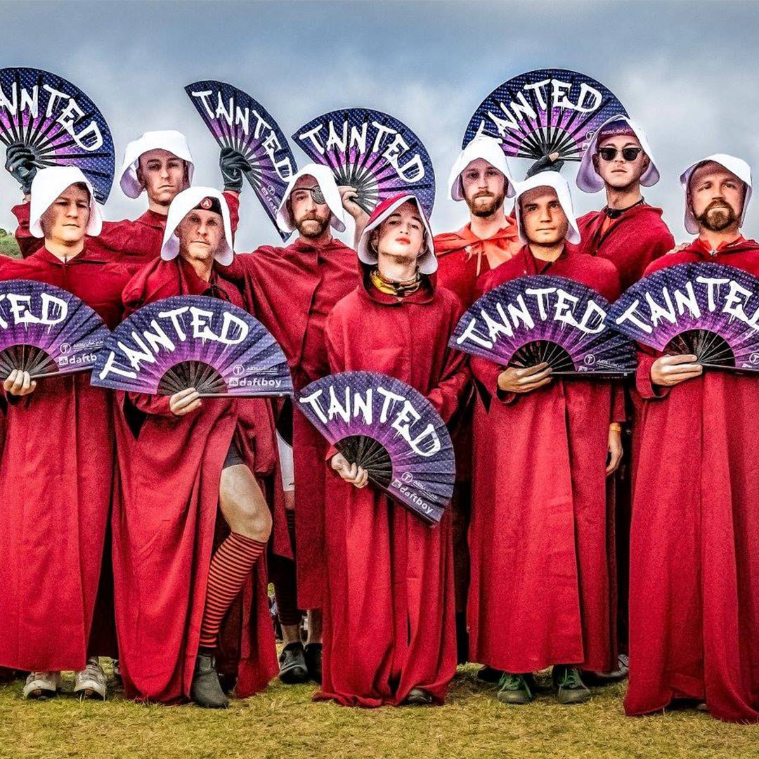 AIDS/LifeCycle riders from Team Tainted in red robes holding custom Daftboy fans to help end AIDS