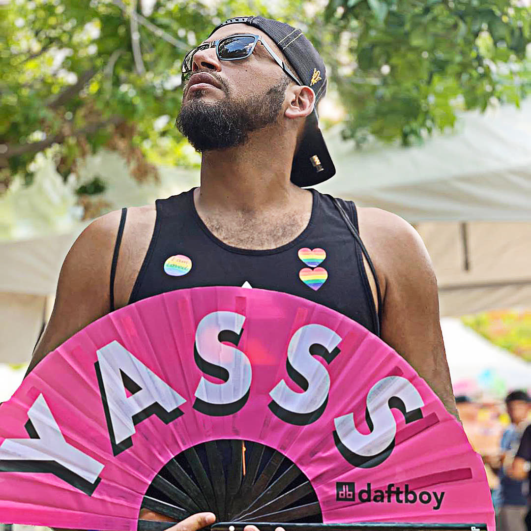 Pride creator holding a pink Daftboy YASSS fan