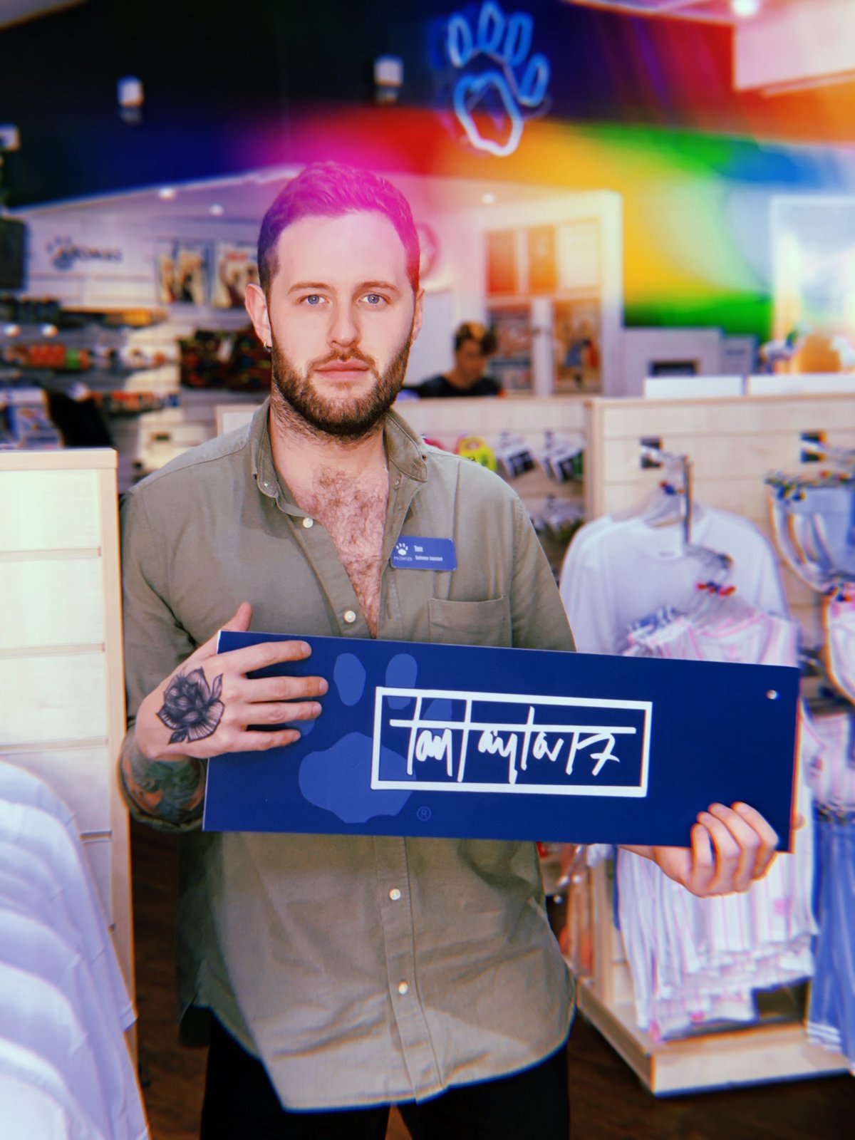 Artist Tom Taylor holding his signed Daftboy fan