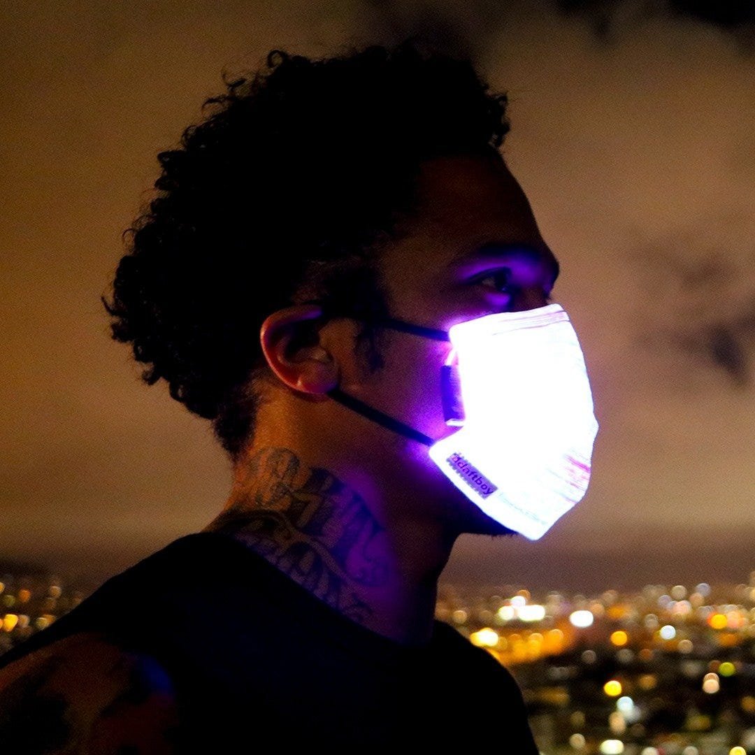 A glowing Daftboy fiber-optic LED mask at night, from The Bold Italic