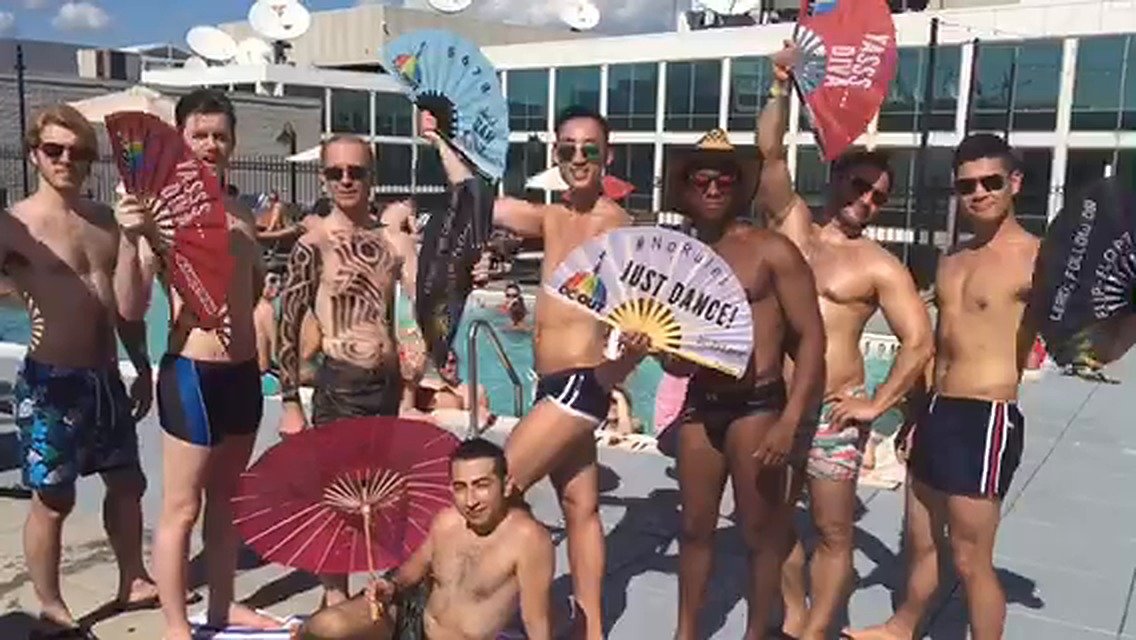 Guests at a DC Out Pride pool party holding up Daftboy fans