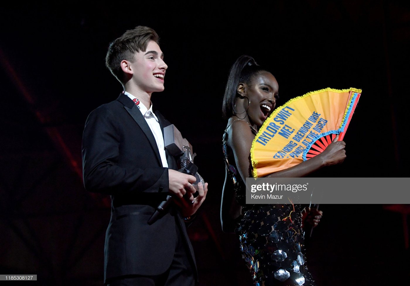 Presenters with a Daftboy award fan on stage at the MTV EMAs