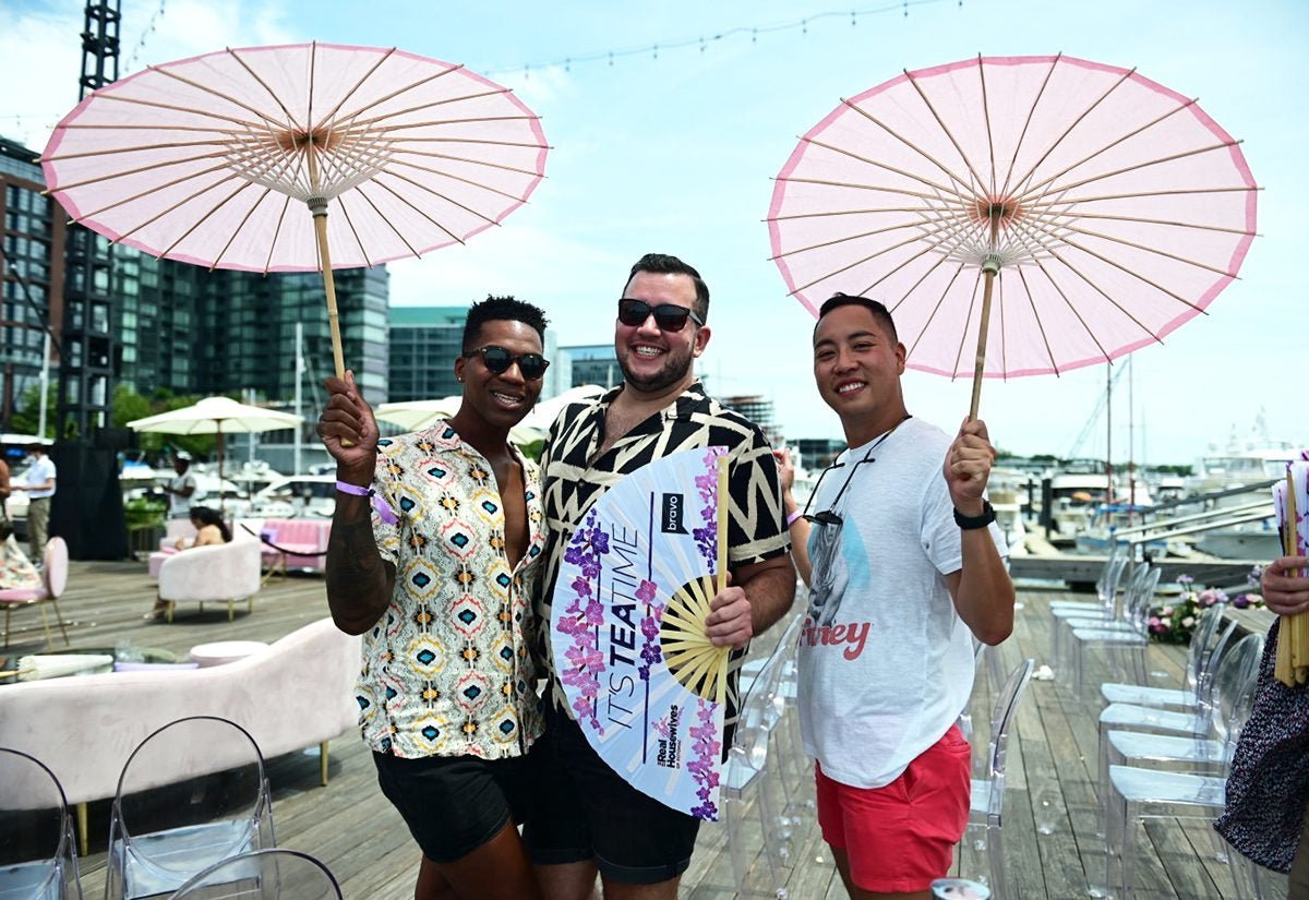 Guests at Bravo's Real Housewives of Potomac tea party holding a Daftboy It's Tea Time fan