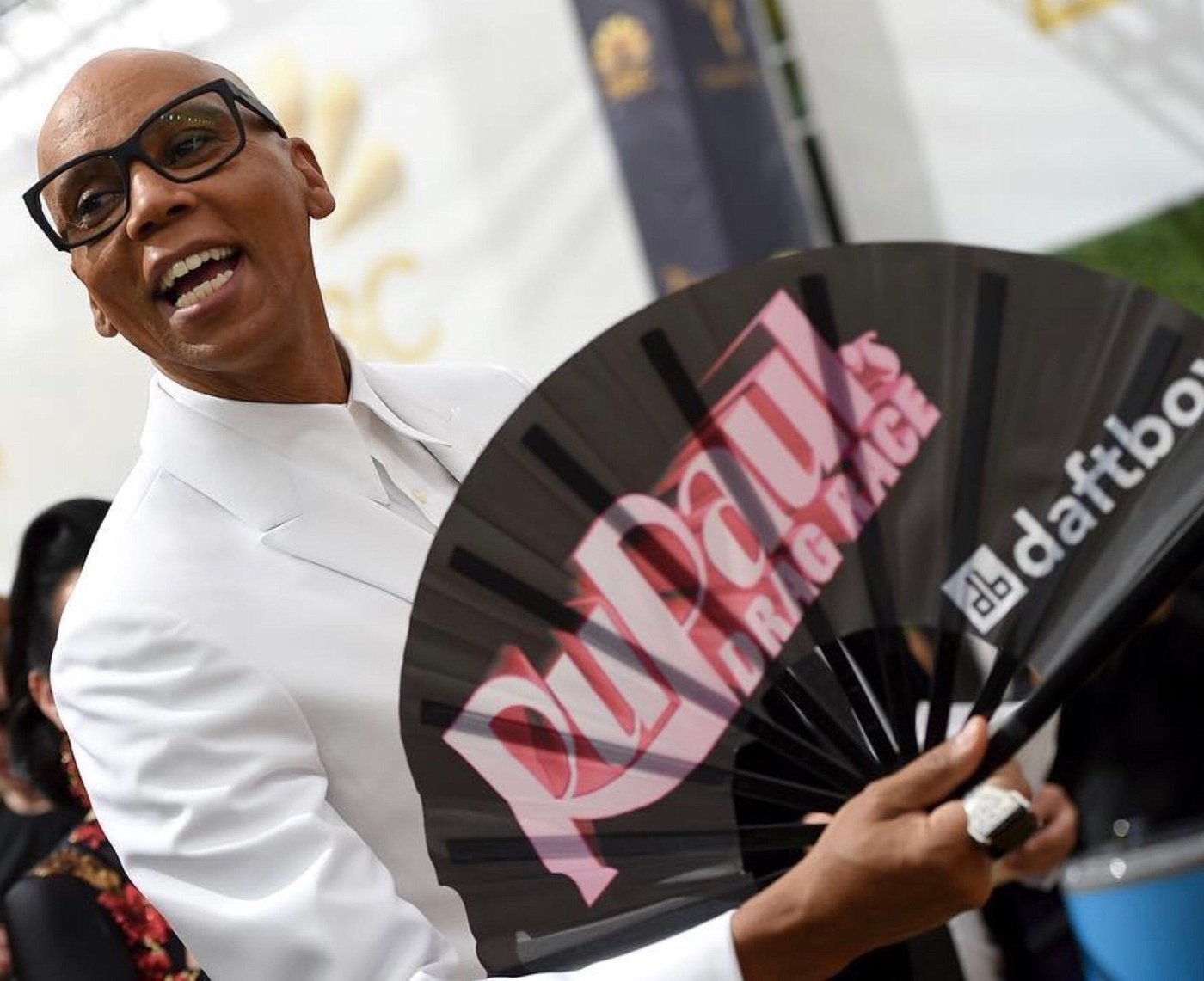RuPaul holding a Daftboy RuPaul's Drag Race fan