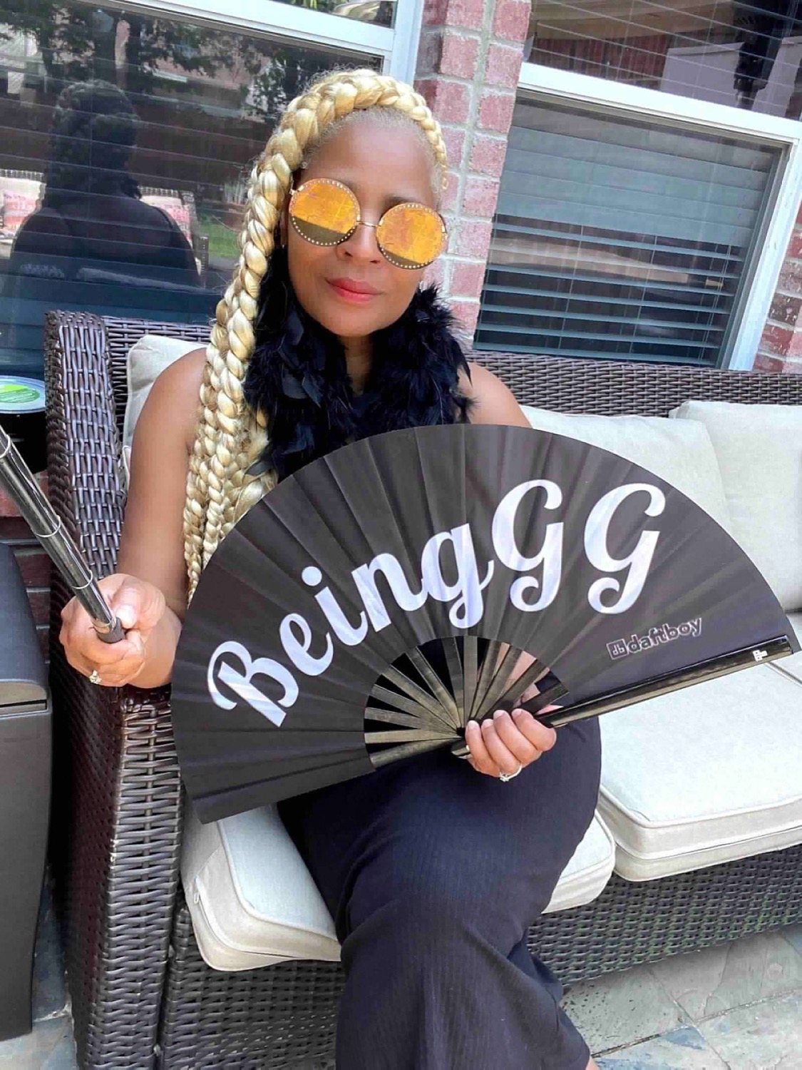 A creator holding her custom Daftboy signature fan